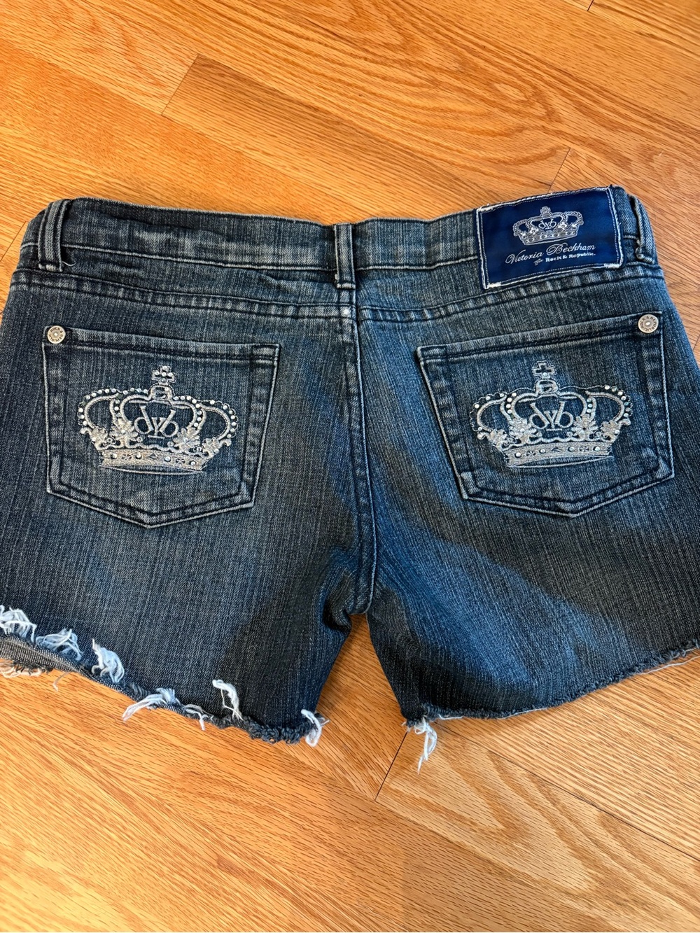 Victoria Beckham Embellished Crown Denim Cutoff Shorts - Dark Blue